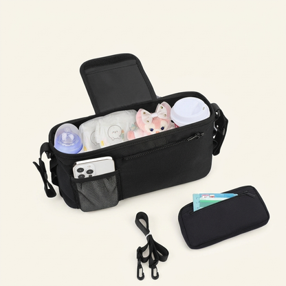 Black diaper bag with baby items on a white background