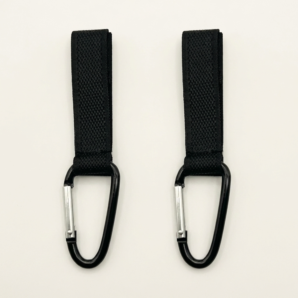 Two black webbing straps with carabiners on a light beige background